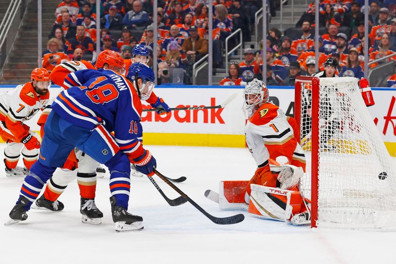 Jan 3, 2025; Edmonton, Alberta, CAN; Edmonton Oilers forward Zach Hyman (18) watches a shot from forward Ryan Nugent-Hopkins (93) get past Anaheim Ducks goaltender Lucas Dostal (1) during the first period at Rogers Place. Mandatory Credit: Perry Nelson-Imagn Images