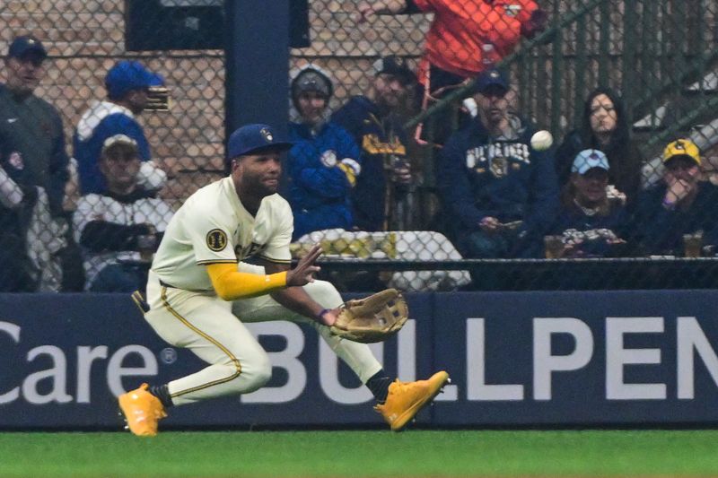 Apr 2, 2024; Milwaukee, Wisconsin, USA; Milwaukee Brewers center fielder Jackson Chourio (11) catches ball ht by Minnesota Twins right fielder Max Kepler (26) in the fourth inning at American Family Field. Mandatory Credit: Benny Sieu-USA TODAY Sports