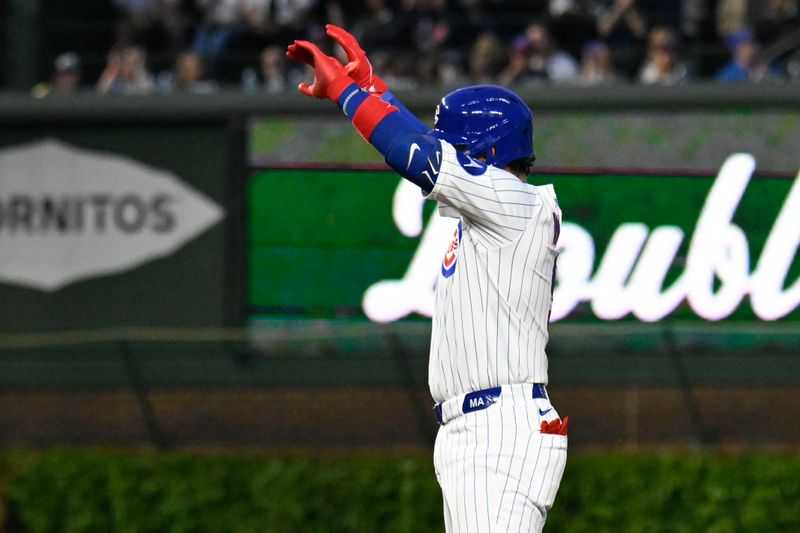 May 12, 2025; Chicago, Illinois, USA;  Chicago Cubs catcher Miguel Amaya (9) points after he doubles against the Miami Marlins during the fifth inning at Wrigley Field. Mandatory Credit: Matt Marton-Imagn Images