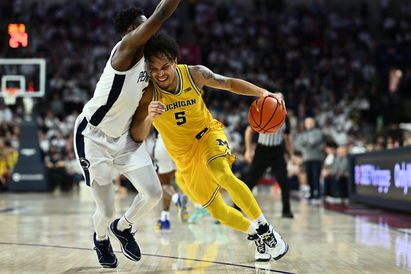 Jan 7, 2024; Philadelphia, Pennsylvania, USA; Michigan Wolverines forward Terrance Williams II (5) drives against Penn State Nittany Lions guard D'Marco Dunn (2) in the second half at The Palestra. Mandatory Credit: Kyle Ross-USA TODAY Sports