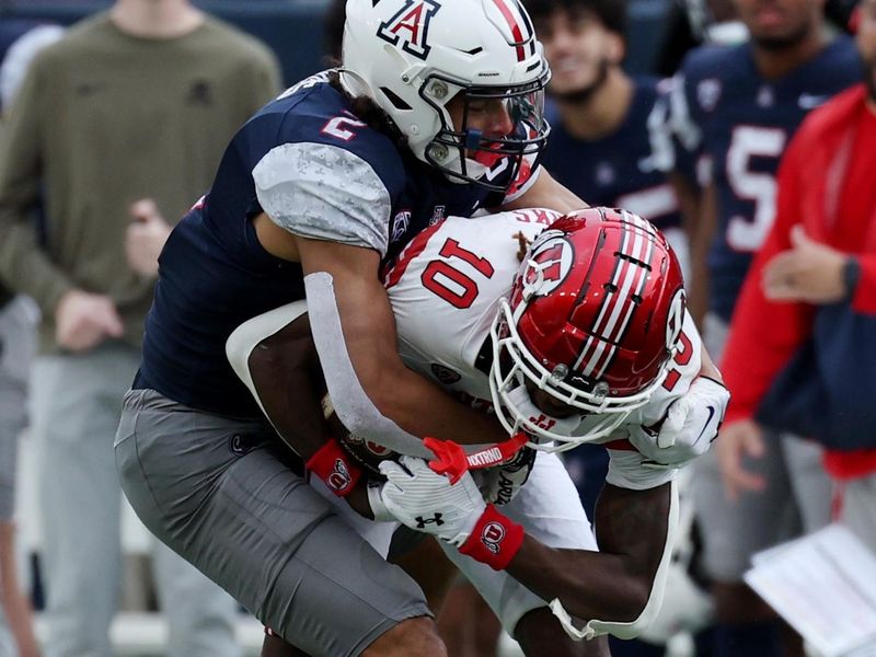 Nov 18, 2023; Tucson, Arizona, USA; Arizona Wildcats cornerback Treydan Stukes (2) tackles Utah Utes safety Johnathan Hall (10) during the second half at Arizona Stadium. Mandatory Credit: Zachary BonDurant-USA TODAY Sports