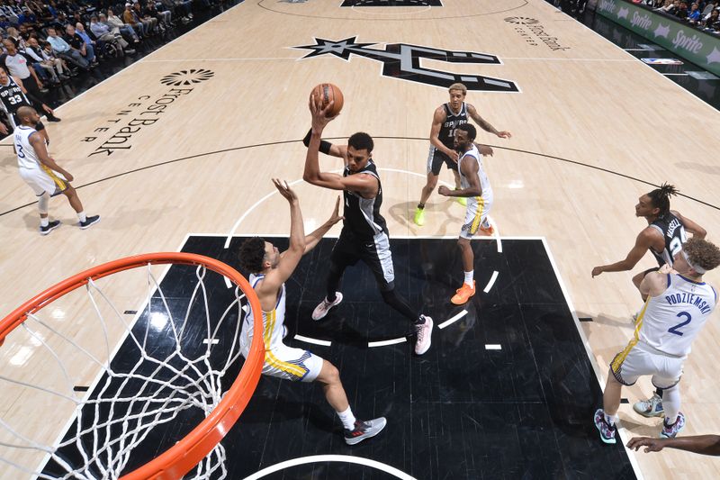 SAN ANTONIO, TX - MARCH 11:  Victor Wembanyama #1 of the San Antonio Spurs handles the ball during the game against the Golden State Warriors on March 11, 2024 at the Frost Bank Center in San Antonio, Texas. NOTE TO USER: User expressly acknowledges and agrees that, by downloading and or using this photograph, user is consenting to the terms and conditions of the Getty Images License Agreement. Mandatory Copyright Notice: Copyright 2024 NBAE (Photos by Michael Gonzales/NBAE via Getty Images)