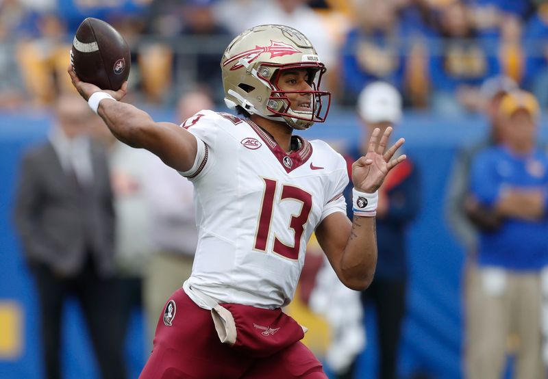 Nov 4, 2023; Pittsburgh, Pennsylvania, USA;  Florida State Seminoles quarterback Jordan Travis (13) passes the ball against the Pittsburgh Panthers during the first quarter at Acrisure Stadium. Mandatory Credit: Charles LeClaire-USA TODAY Sports