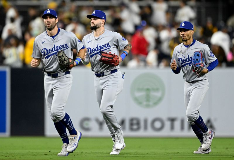 Oct 9, 2024; San Diego, California, USA; Los Angeles Dodgers outfielder Chris Taylor (3), outfielder Andy Pages (44) and shortstop Mookie Betts (50) celebrate after winning game four of the NLDS for the 2024 MLB Playoffs against the San Diego Padres at Petco Park.  Mandatory Credit: Denis Poroy-Imagn Images