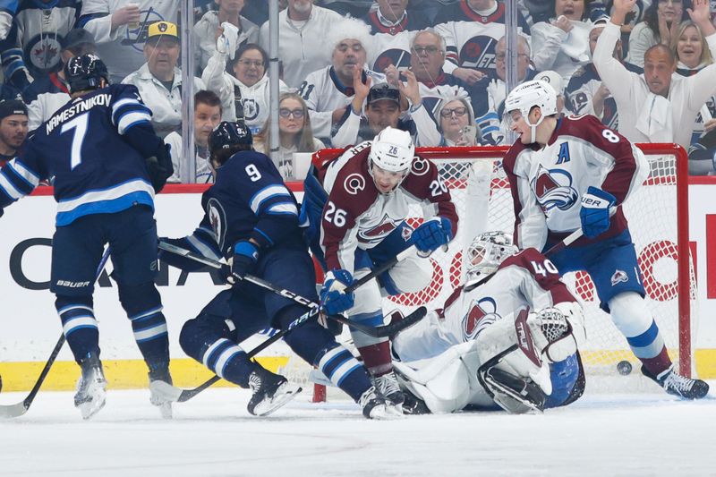 Apr 23, 2024; Winnipeg, Manitoba, CAN; Winnipeg Jets forward David Gustafsson (19) scores on Colorado Avalanche goalie Alexander Georgiev (40) during the first period in game two of the first round of the 2024 Stanley Cup Playoffs at Canada Life Centre. Mandatory Credit: Terrence Lee-USA TODAY Sports