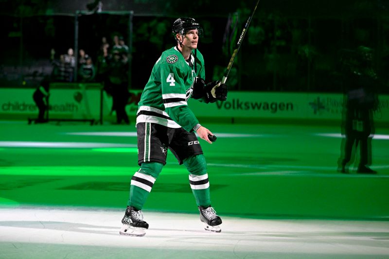 Jan 25, 2024; Dallas, Texas, USA; Dallas Stars defenseman Miro Heiskanen (4) throws a puck to the fans after the Stars defeat the Anaheim Ducks in the overtime period at the American Airlines Center. Mandatory Credit: Jerome Miron-USA TODAY Sports