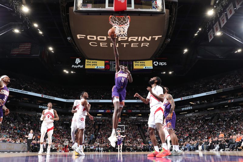 PHOENIX, AZ - MARCH 7: Bol Bol #11 of the Phoenix Suns drives to the basket during the game against the Toronto Raptors on March 7, 2024 at Footprint Center in Phoenix, Arizona. NOTE TO USER: User expressly acknowledges and agrees that, by downloading and or using this photograph, user is consenting to the terms and conditions of the Getty Images License Agreement. Mandatory Copyright Notice: Copyright 2024 NBAE (Photo by Jeff Haynes/NBAE via Getty Images)