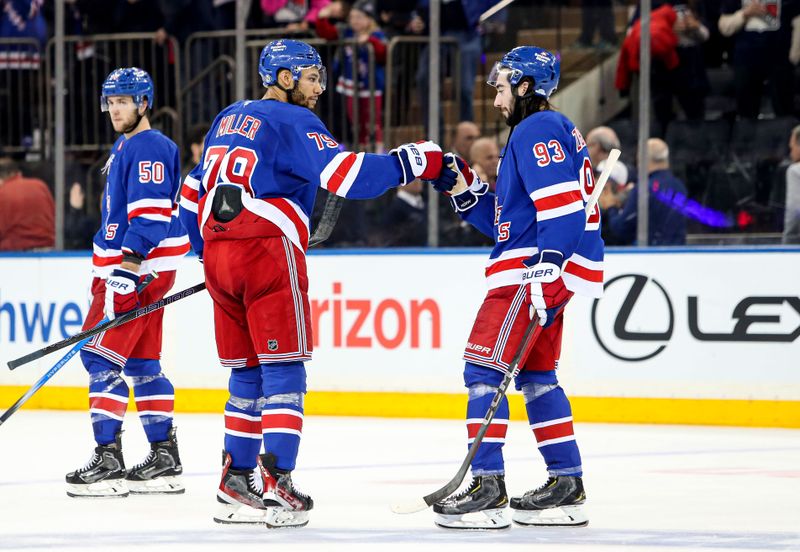 Jan 18, 2025; New York, New York, USA; New York Rangers defenseman K'Andre Miller (79) celebrates with center Mika Zibanejad (93) after a 1-0 shootout win against the Columbus Blue Jackets at Madison Square Garden. Mandatory Credit: Danny Wild-Imagn Images