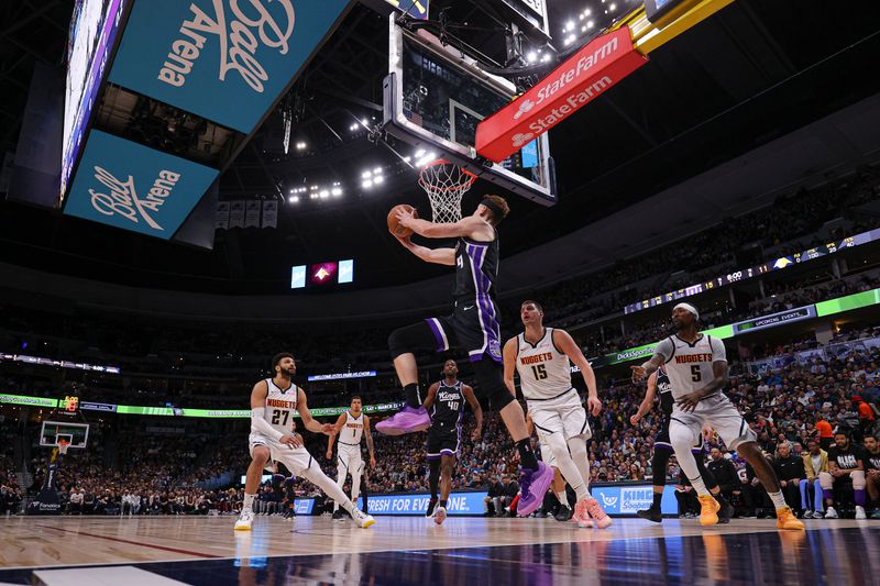 DENVER, COLORADO - FEBRUARY 28: Kevin Huerter #9 of the Sacramento Kings goes for a lay up during the first quarter of the game against the Denver Nuggets at Ball Arena on February 28, 2024 in Denver, Colorado. NOTE TO USER: User expressly acknowledges and agrees that, by downloading and or using this photograph, User is consenting to the terms and conditions of the Getty Images License Agreement. (Photo by Alysa Rubin/Clarkson Creative/Getty Images)