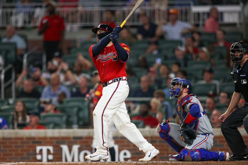 Apr 19, 2024; Atlanta, Georgia, USA; Atlanta Braves catcher Travis d'Arnaud (16) hits a grand slam against the Texas Rangers in the sixth inning at Truist Park. Mandatory Credit: Brett Davis-USA TODAY Sports