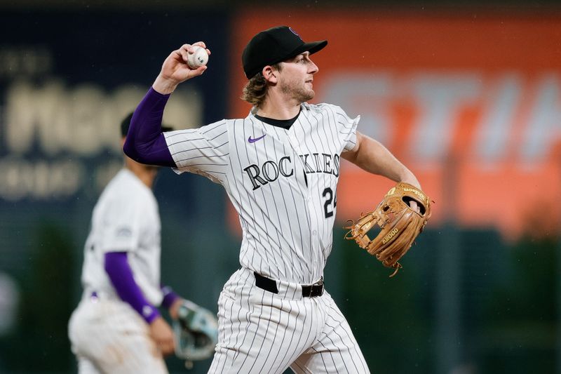 Aug 6, 2024; Denver, Colorado, USA; Colorado Rockies third baseman Ryan McMahon (24) throws to first for an out in the seventh inning against the New York Mets at Coors Field. Mandatory Credit: Isaiah J. Downing-USA TODAY Sports