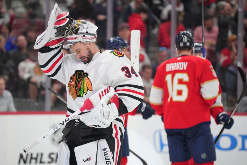 Feb 1, 2025; Sunrise, Florida, USA;  Chicago Blackhawks goaltender Petr Mrazek (34) takes a moment after a goal by Florida Panthers left wing Matthew Tkachuk (19) in the second period at Amerant Bank Arena. Mandatory Credit: Jim Rassol-Imagn Images