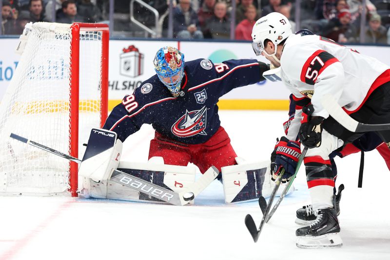 Dec 11, 2025; Columbus, Ohio, USA; Columbus Blue Jackets goaltender Elvis Merzlikins (90) saves the puck as Ottawa Senators left wing David Perron (57) shoots during the first period at Nationwide Arena. Mandatory Credit: Joseph Maiorana-Imagn Images