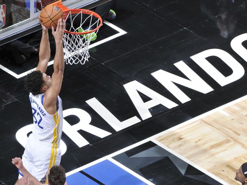 ORLANDO, FL - MARCH 27: Trayce Jackson-Davis #32 of the Golden State Warriors  drives to the basket during the game against the Orlando Magic on March 27, 2024 at Amway Center in Orlando, Florida. NOTE TO USER: User expressly acknowledges and agrees that, by downloading and or using this photograph, User is consenting to the terms and conditions of the Getty Images License Agreement. Mandatory Copyright Notice: Copyright 2024 NBAE (Photo by Fernando Medina/NBAE via Getty Images)