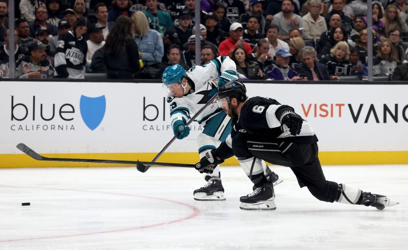 Oct 24, 2024; Los Angeles, California, USA; San Jose Sharks center Tyler Toffoli (73) shoots against Los Angeles Kings defenseman Joel Edmundson (6) during the third period at Crypto.com Arena. Mandatory Credit: Jason Parkhurst-Imagn Images