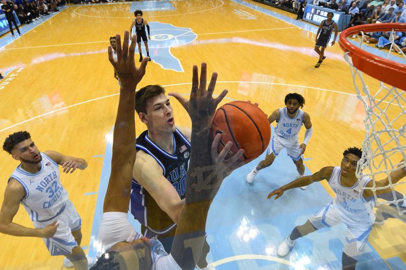 Mar 4, 2023; Chapel Hill, North Carolina, USA; Duke Blue Devils center Kyle Filipowski (30) shoots as North Carolina Tar Heels forward Armando Bacot (5) defends in the first half at Dean E. Smith Center. Mandatory Credit: Bob Donnan-USA TODAY Sports