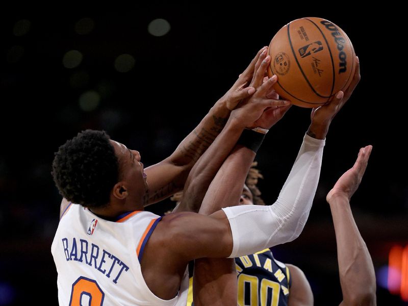 NEW YORK, NEW YORK - APRIL 09:  RJ Barrett #9 of the New York Knicks heads for the net as Bennedict Mathurin #00 and Aaron Nesmith #23 of the Indiana Pacers defend in the second half at Madison Square Garden on April 09, 2023 in New York City. NOTE TO USER: User expressly acknowledges and agrees that, by downloading and or using this photograph, User is consenting to the terms and conditions of the Getty Images License Agreement. (Photo by Elsa/Getty Images)