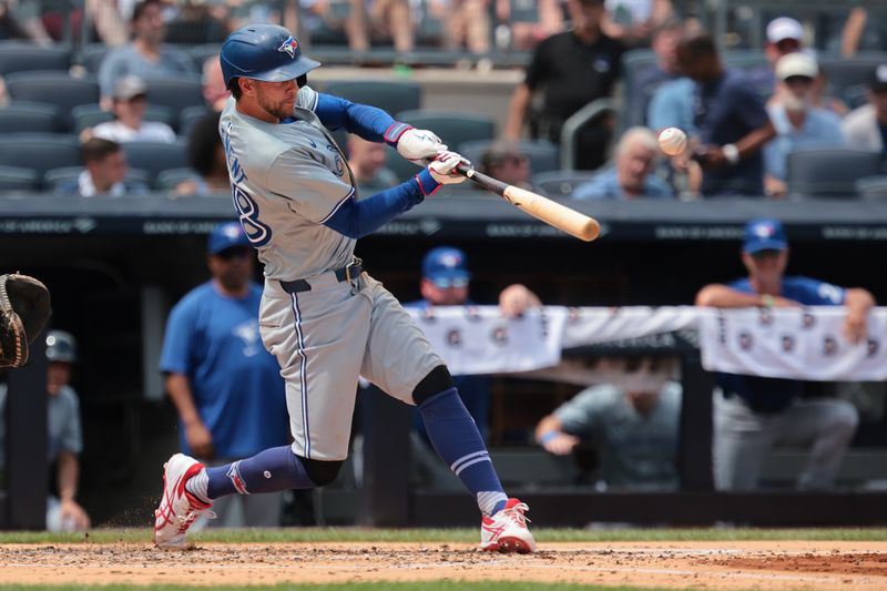 Aug 4, 2024; Bronx, New York, USA; Toronto Blue Jays third baseman Ernie Clement (28) hits an RBI single during the second inning against the New York Yankees at Yankee Stadium. Mandatory Credit: Vincent Carchietta-USA TODAY Sports