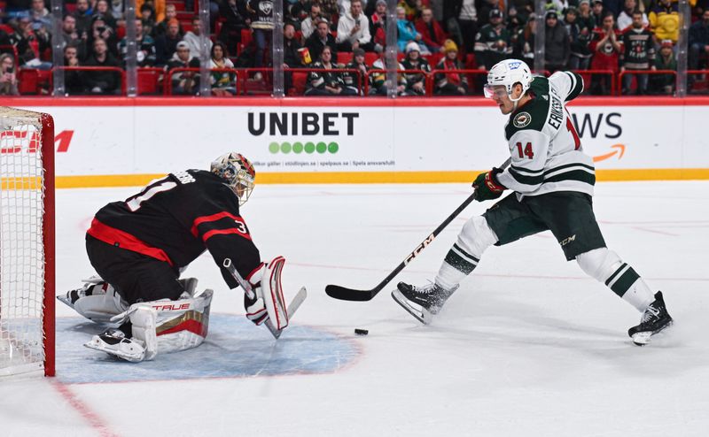 Nov 18, 2023; Stockholm, SWE; Minnesota Wild center Joel Eriksson Ek (14) shoots against Ottawa Senators goaltender Anton Forsberg (31) in the overtime shootout during a Global Series NHL hockey game at Avicii Arena. Mandatory Credit: Per Haljestam-USA TODAY Sports