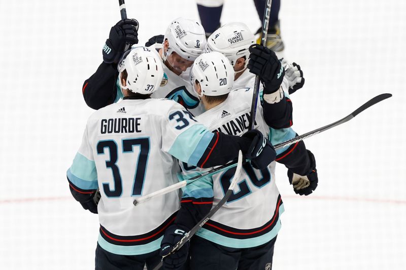 Jan 11, 2024; Washington, District of Columbia, USA; Seattle Kraken defenseman Justin Schultz (4) celebrates with teammates after scoring a goal against the Washington Capitals in the second period at Capital One Arena. Mandatory Credit: Geoff Burke-USA TODAY Sports