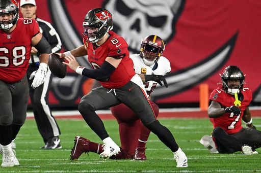 Tampa Bay Buccaneers quarterback Baker Mayfield (6) scrambles away from Washington Commanders linebacker Bobby Wagner during the first half of an NFL wild-card playoff football game in Tampa, Fla., Sunday, Jan. 12, 2025. (AP Photo/Jason Behnken)