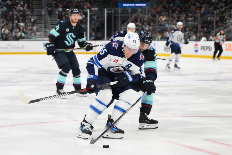 Mar 8, 2024; Seattle, Washington, USA; Winnipeg Jets center Mark Scheifele (55) and Seattle Kraken right wing Jordan Eberle (7) play the puck during the third period at Climate Pledge Arena. Mandatory Credit: Steven Bisig-USA TODAY Sports