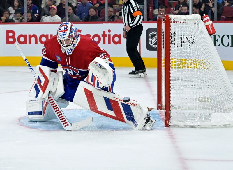 Oct 26, 2024; Montreal, Quebec, CAN; Montreal Canadiens goalie Sam Montembeault (35) makes a save against the St.Louis Blues during the second period at the Bell Centre. Mandatory credit: Eric Bolte-Imagn Images