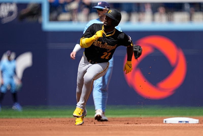 Jun 1, 2024; Toronto, Ontario, CAN; Pittsburgh Pirates designated hitter Andrew McCutchen (22) advances to third base on a double by first baseman Connor Joe (not pictured) against the Toronto Blue Jays during the first inning at Rogers Centre. Mandatory Credit: John E. Sokolowski-USA TODAY Sports