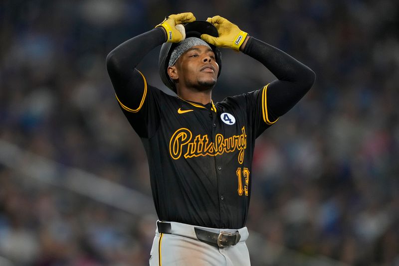 Jun 2, 2024; Toronto, Ontario, CAN; Pittsburgh Pirates third baseman Ke'Bryan Hayes (13) reacts after hitting a fly ball to the Toronto Blue Jays during the sixth inning at Rogers Centre. Mandatory Credit: John E. Sokolowski-USA TODAY Sports