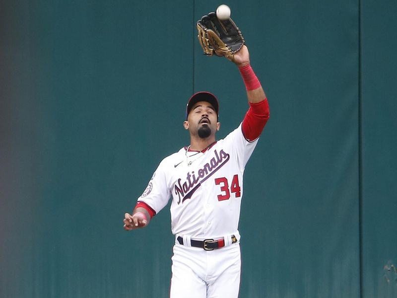 Jun 22, 2023; Washington, District of Columbia, USA; Washington Nationals center fielder Derek Hill (34) catches a fly ball for an out in the first inning against the Arizona Diamondbacks at Nationals Park. Mandatory Credit: Amber Searls-USA TODAY Sports