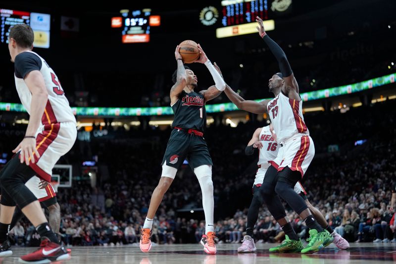 PORTLAND, OREGON - FEBRUARY 27: Anfernee Simons #1 of the Portland Trail Blazers looks to shoot against Bam Adebayo #13 of the Miami Heat during the first half at Moda Center on February 27, 2024 in Portland, Oregon. NOTE TO USER: User expressly acknowledges and agrees that, by downloading and or using this photograph, User is consenting to the terms and conditions of the Getty Images License Agreement. (Photo by Soobum Im/Getty Images)