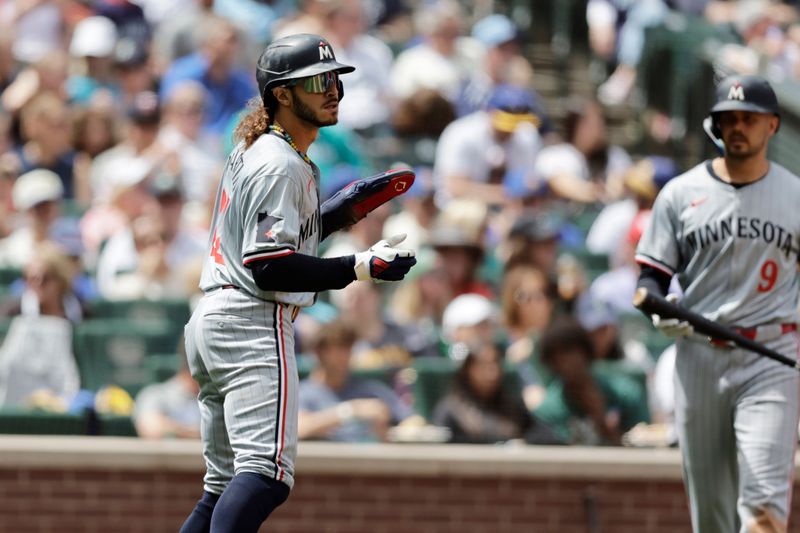 Jun 30, 2024; Seattle, Washington, USA; Minnesota Twins second baseman Austin Martin (82) claps after scoring against the Seattle Mariners during the fifth inning at T-Mobile Park. Mandatory Credit: John Froschauer-USA TODAY Sports