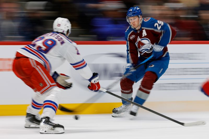 Nov 20, 2025; Denver, Colorado, USA; Colorado Avalanche center Nathan MacKinnon (29) controls the puck as New York Rangers defenseman Matthew Robertson (29) defends in the second period at Ball Arena. Mandatory Credit: Isaiah J. Downing-Imagn Images