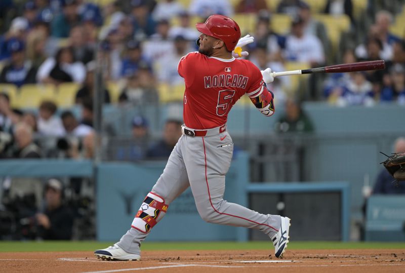 May 16, 2025; Los Angeles, California, USA; Los Angeles Angels third baseman Yoan Moncada (5) hits a two-run home run during the first inning against the Los Angeles Dodgers at Dodger Stadium. Mandatory Credit: Jayne Kamin-Oncea-Imagn Images