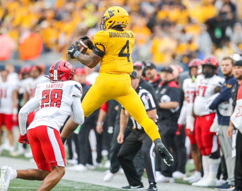 Sep 23, 2023; Morgantown, West Virginia, USA; West Virginia Mountaineers running back CJ Donaldson Jr. (4) catches a pass against the Texas Tech Red Raiders during the fourth quarter at Mountaineer Field at Milan Puskar Stadium. Mandatory Credit: Ben Queen-USA TODAY Sports
