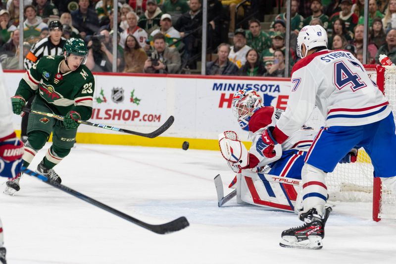 Dec 21, 2023; Saint Paul, Minnesota, USA; Minnesota Wild center Marco Rossi (23) shoots on Montreal Canadiens goaltender Sam Montembeault (35) in the third period at Xcel Energy Center. Mandatory Credit: Matt Blewett-USA TODAY Sports