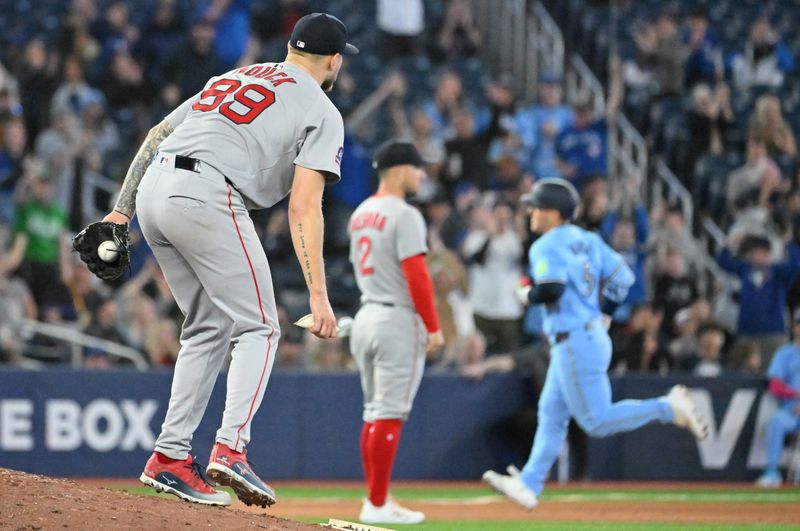 May 1, 2025; Toronto, Ontario, CAN; Boston Red Sox pitcher Tanner Houck (89) watches Toronto Blue Jays center fielder Daulton Varsho (5) round the bases after hitting a solo home run in the seventh inning at Rogers Centre. Mandatory Credit: Dan Hamilton-Imagn Images