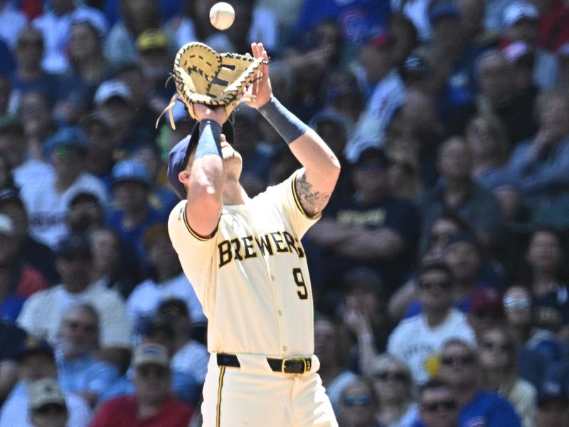 May 30, 2024; Milwaukee, Wisconsin, USA; Milwaukee Brewers first baseman Jake Bauers (9) catches a fly ball against the Chicago Cubs in the sixth inning at American Family Field. Mandatory Credit: Michael McLoone-USA TODAY Sports