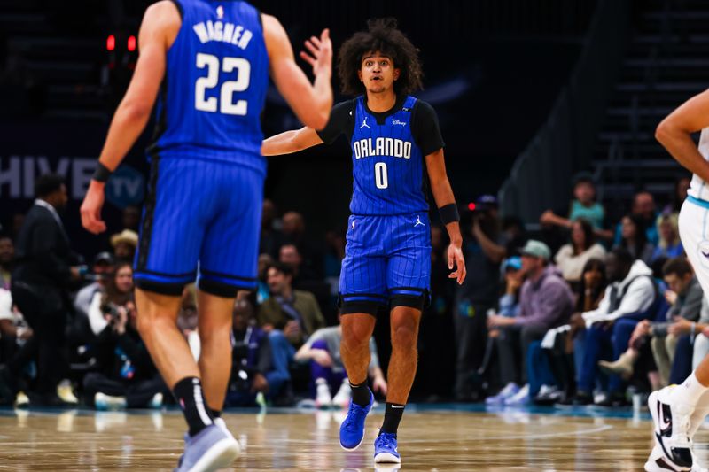 CHARLOTTE, NORTH CAROLINA - NOVEMBER 25: Anthony Black #0 speaks with Franz Wagner #22 of the Orlando Magic during the first half of a basketball game against the Charlotte Hornets at Spectrum Center on November 25, 2024 in Charlotte, North Carolina. NOTE TO USER: User expressly acknowledges and agrees that, by downloading and or using this photograph, User is consenting to the terms and conditions of the Getty Images License Agreement. (Photo by David Jensen/Getty Images)