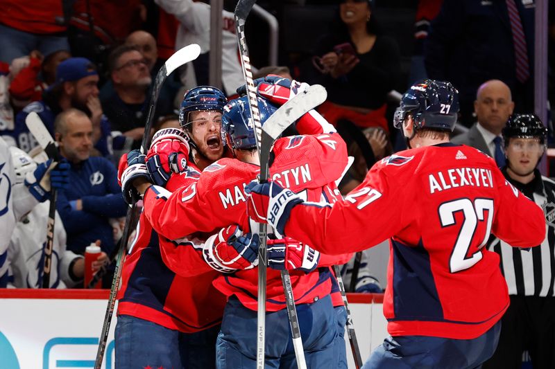 Apr 13, 2024; Washington, District of Columbia, USA; Washington Capitals center Nic Dowd (26) celebrates with teammates after scoring a goal against the Tampa Bay Lightning in the third period at Capital One Arena. Mandatory Credit: Geoff Burke-USA TODAY Sports