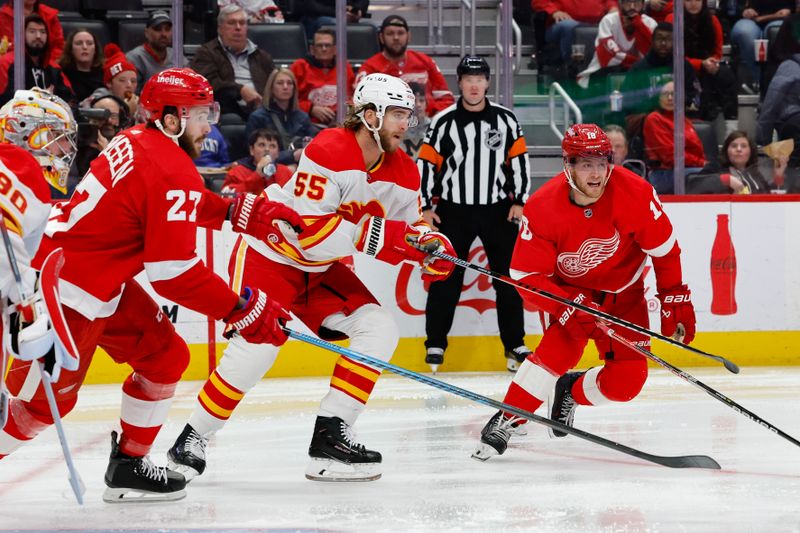 Oct 22, 2023; Detroit, Michigan, USA;  Detroit Red Wings center Michael Rasmussen (27) Calgary Flames defenseman Noah Hanifin (55) and center Andrew Copp (18) skate in the second period at Little Caesars Arena. Mandatory Credit: Rick Osentoski-USA TODAY Sports