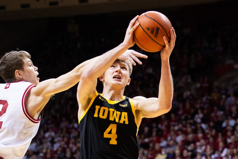 Jan 30, 2024; Bloomington, Indiana, USA; Iowa Hawkeyes guard Josh Dix (4) shoots the ball while Indiana Hoosiers guard Gabe Cupps (2) defends in the second half at Simon Skjodt Assembly Hall. Mandatory Credit: Trevor Ruszkowski-USA TODAY Sports