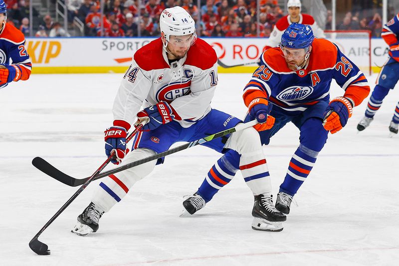 Mar 19, 2024; Edmonton, Alberta, CAN; Montreal Canadiens forward Nick Suzuki (14) protects the puck from Edmonton Oilers forward Leon Draisaitl (29) during the second period at Rogers Place. Mandatory Credit: Perry Nelson-USA TODAY Sports