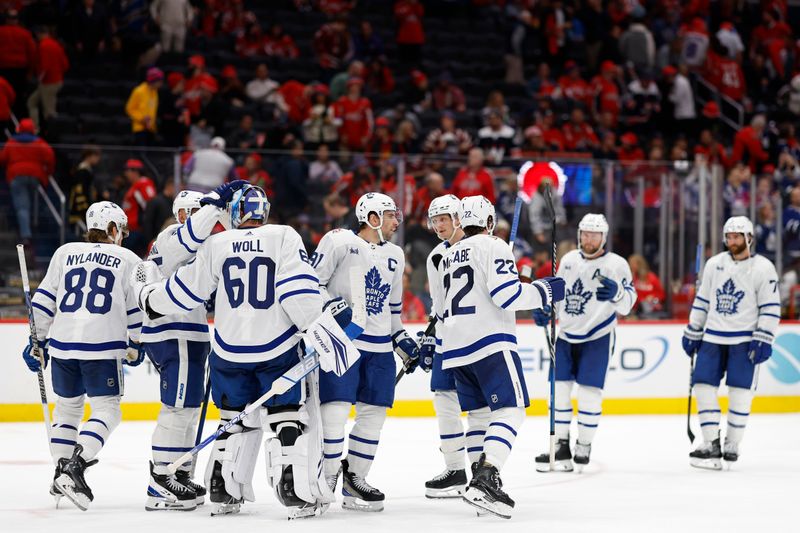 Oct 24, 2023; Washington, District of Columbia, USA; Toronto Maple Leafs goaltender Joseph Woll (60) celebrates with teammates after their game against the Washington Capitals at Capital One Arena. Mandatory Credit: Geoff Burke-USA TODAY Sports