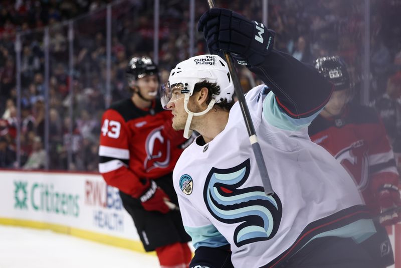 Dec 6, 2024; Newark, New Jersey, USA; Seattle Kraken left wing Andre Burakovsky (95) celebrates his goal against the New Jersey Devils during the first period at Prudential Center. Mandatory Credit: Ed Mulholland-Imagn Images