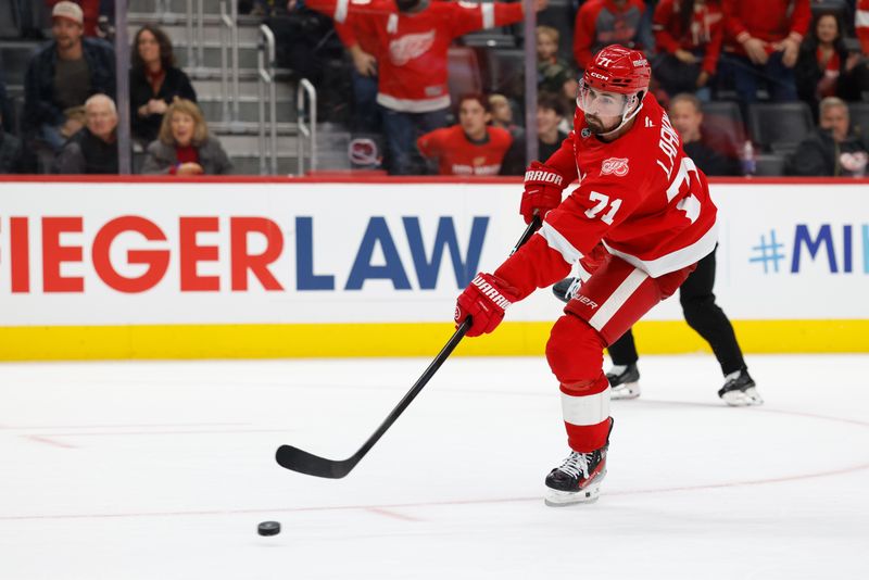 Nov 22, 2025; Detroit, Michigan, USA;  Detroit Red Wings center Dylan Larkin (71) takes a shot in overtime against the Columbus Blue Jackets at Little Caesars Arena. Mandatory Credit: Rick Osentoski-Imagn Images