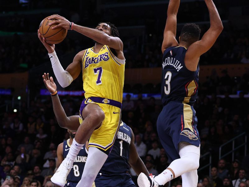 LOS ANGELES, CALIFORNIA - NOVEMBER 02: Troy Brown Jr. #7 of the Los Angeles Lakers attempts a layup past CJ McCollum #3 and Zion Williamson #1 of the New Orleans Pelicans during a 120-117 Lakers overtime win at Crypto.com Arena on November 02, 2022 in Los Angeles, California. NOTE TO USER: User expressly acknowledges and agrees that, by downloading and/or using this Photograph, user is consenting to the terms and conditions of the Getty Images License Agreement. Mandatory Copyright Notice: Copyright 2022 NBAE (Photo by Harry How/Getty Images)