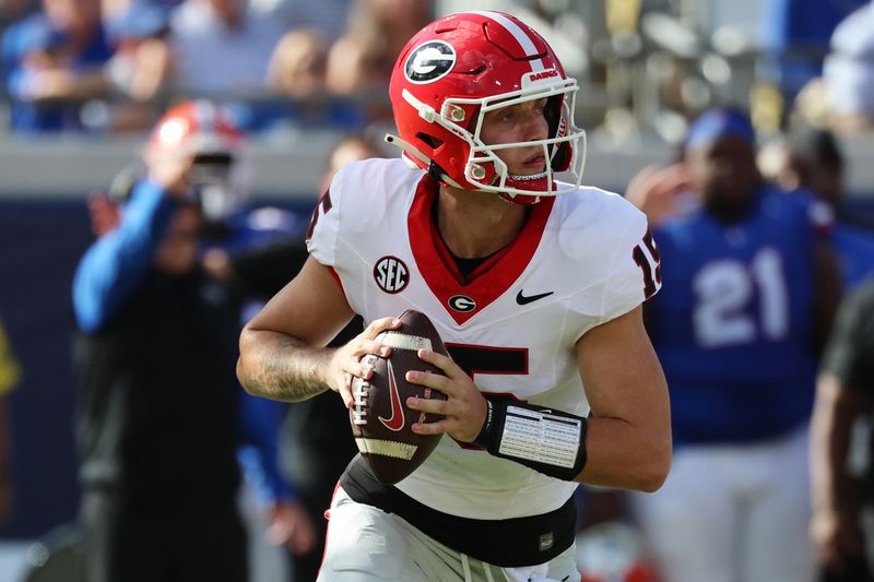 Oct 28, 2023; Jacksonville, Florida, USA; Georgia Bulldogs quarterback Carson Beck (15) rolls out to throw against the Florida Gators during the first quarter at EverBank Stadium. Mandatory Credit: Kim Klement Neitzel-USA TODAY Sports