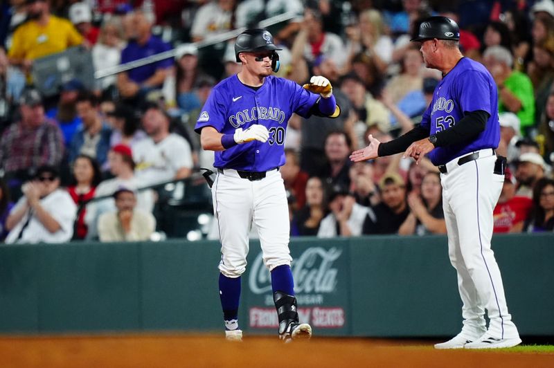 Sep 24, 2024; Denver, Colorado, USA; Colorado Rockies third baseman Aaron Schunk (30) celebrates his infield single RBI in the fifth inning against the St. Louis Cardinals at Coors Field. Mandatory Credit: Ron Chenoy-Imagn Images