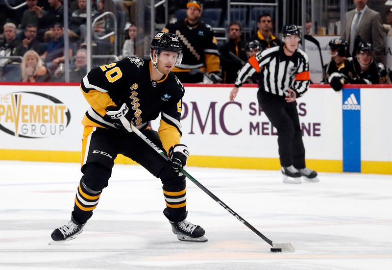 Oct 26, 2023; Pittsburgh, Pennsylvania, USA; Pittsburgh Penguins center Lars Eller (20) skates the puck up ice against the Colorado Avalanche during the third period at PPG Paints Arena. The Penguins shutout the Avalanche 4-0. Mandatory Credit: Charles LeClaire-USA TODAY Sports